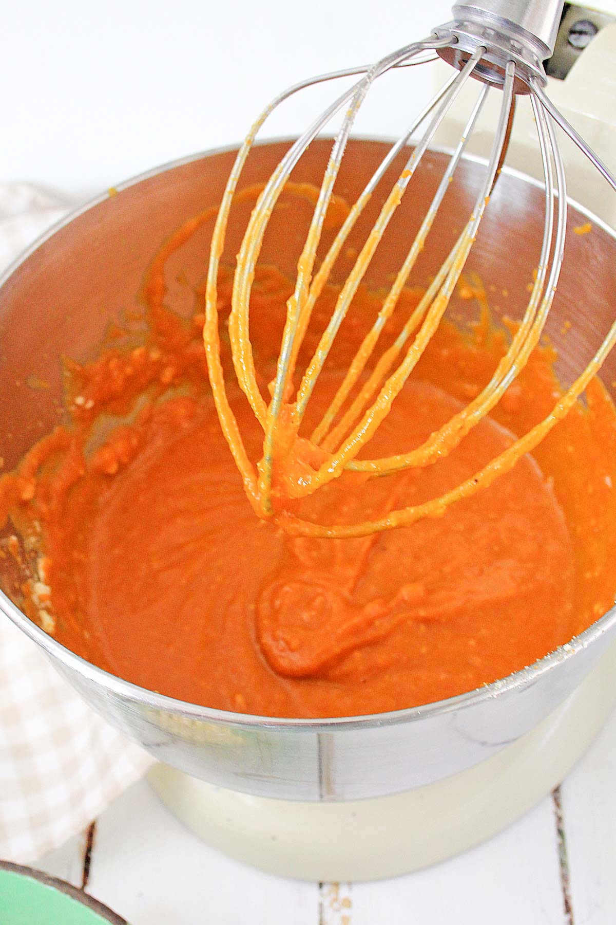 Kitchen Aid beater above a bowl of pumpkin filing