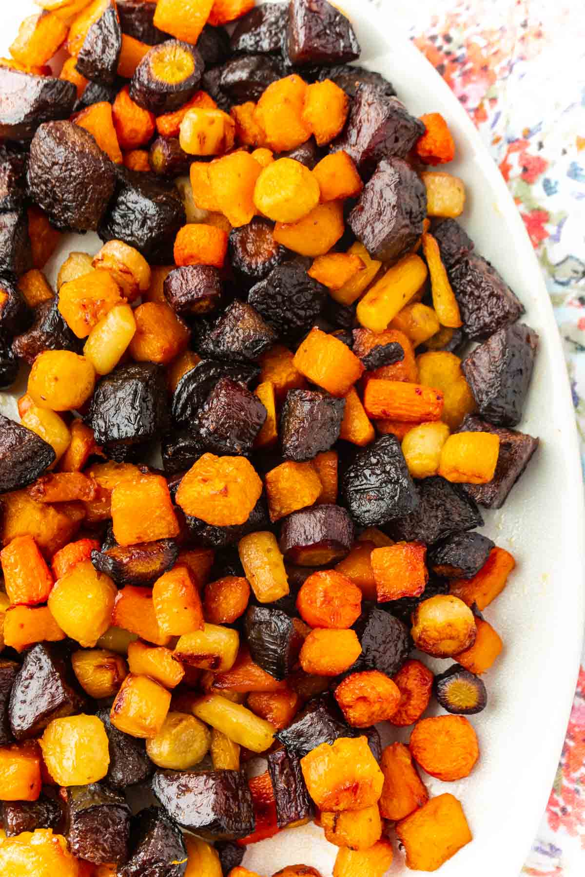 A white bowl filled with roasted root vegetables