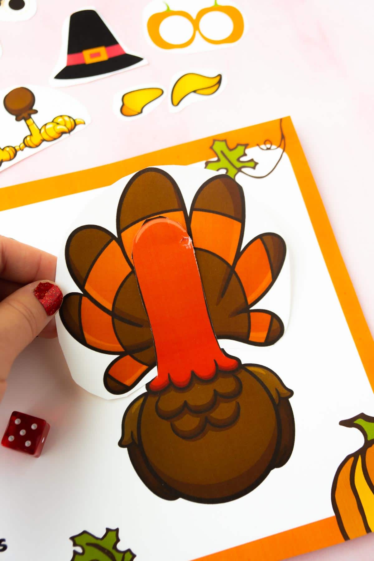 Hand holding turkey feathers on a roll a turkey game