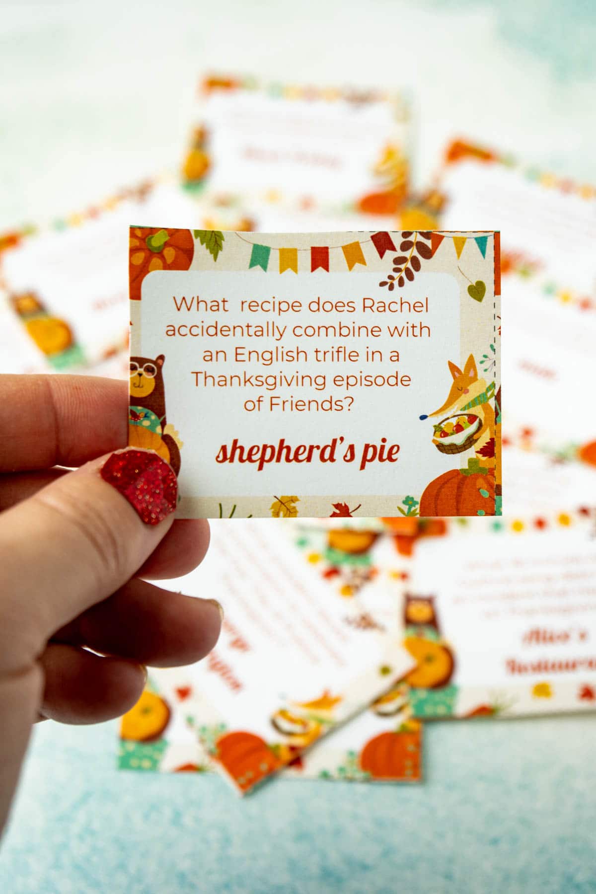 Hand holding a Thanksgiving trivia question card