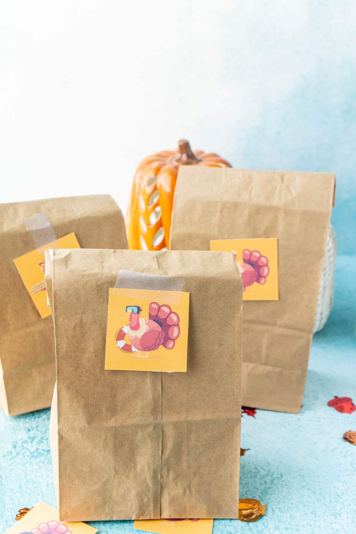 Three brown paper bags with Thanksgiving turkey hunt card