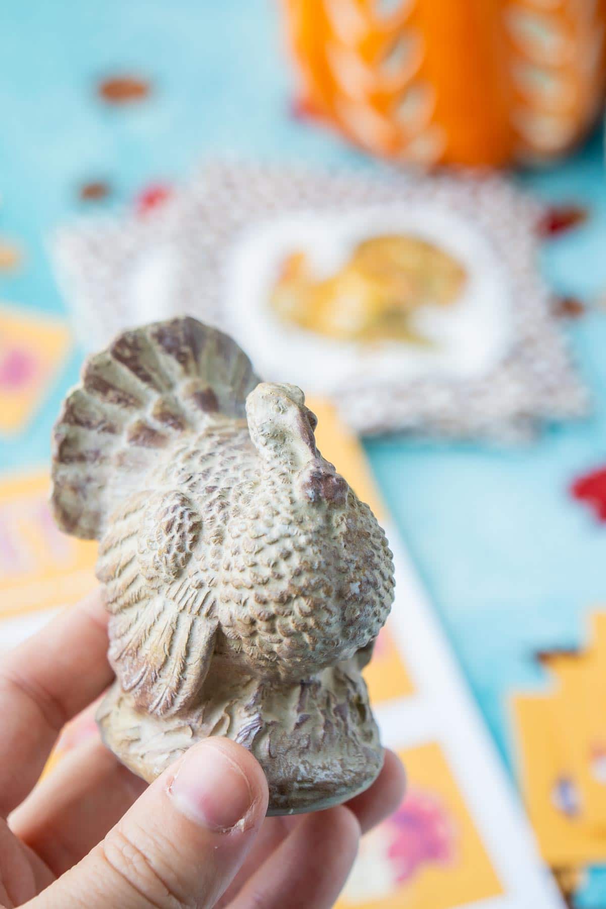 Ceramic turkey being held in a woman's hand