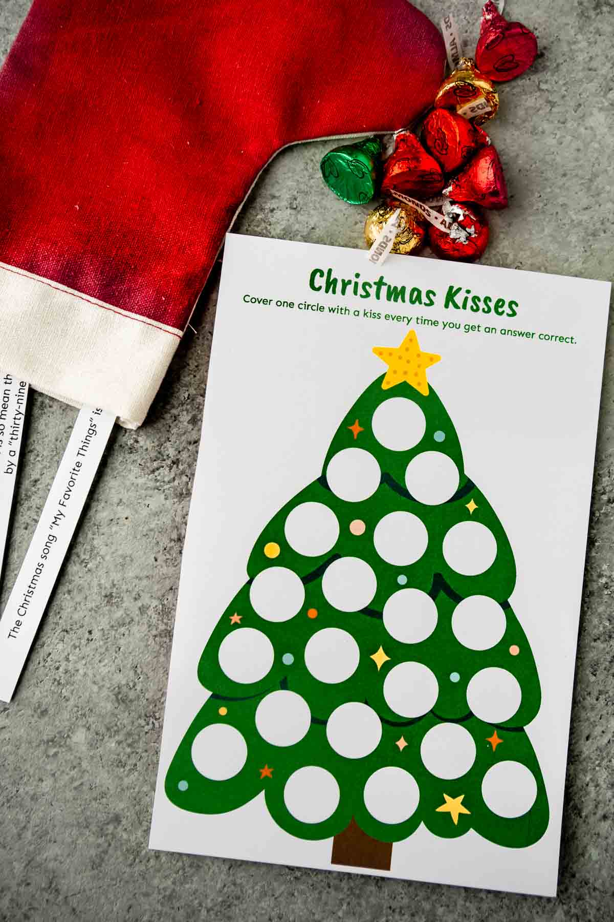 Printed out Christmas trivia game card with questions nearby