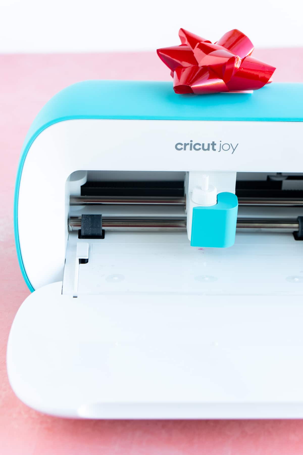 Cricut Joy with a red bow on top