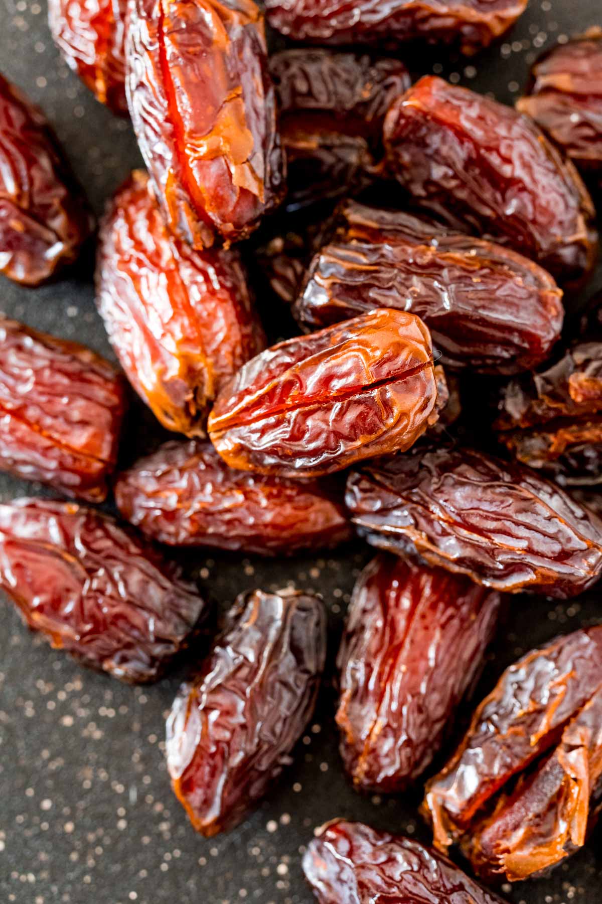 A plate full of dates with slits cut 