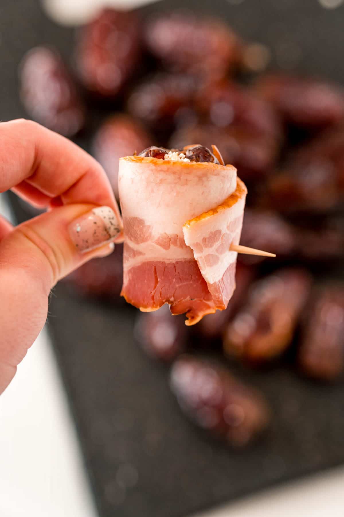 Bacon wrapped around a stuffed date