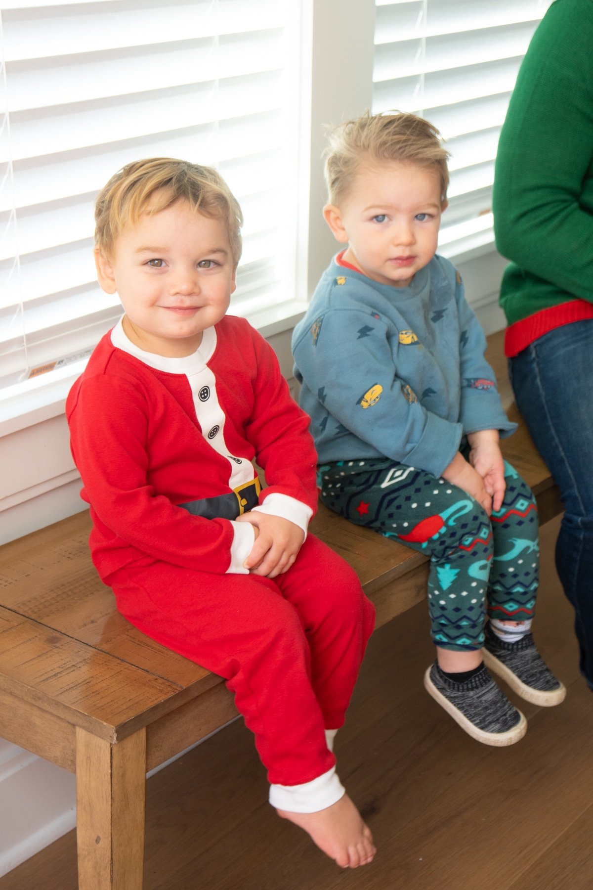 Two toddler boys sitting on a bench