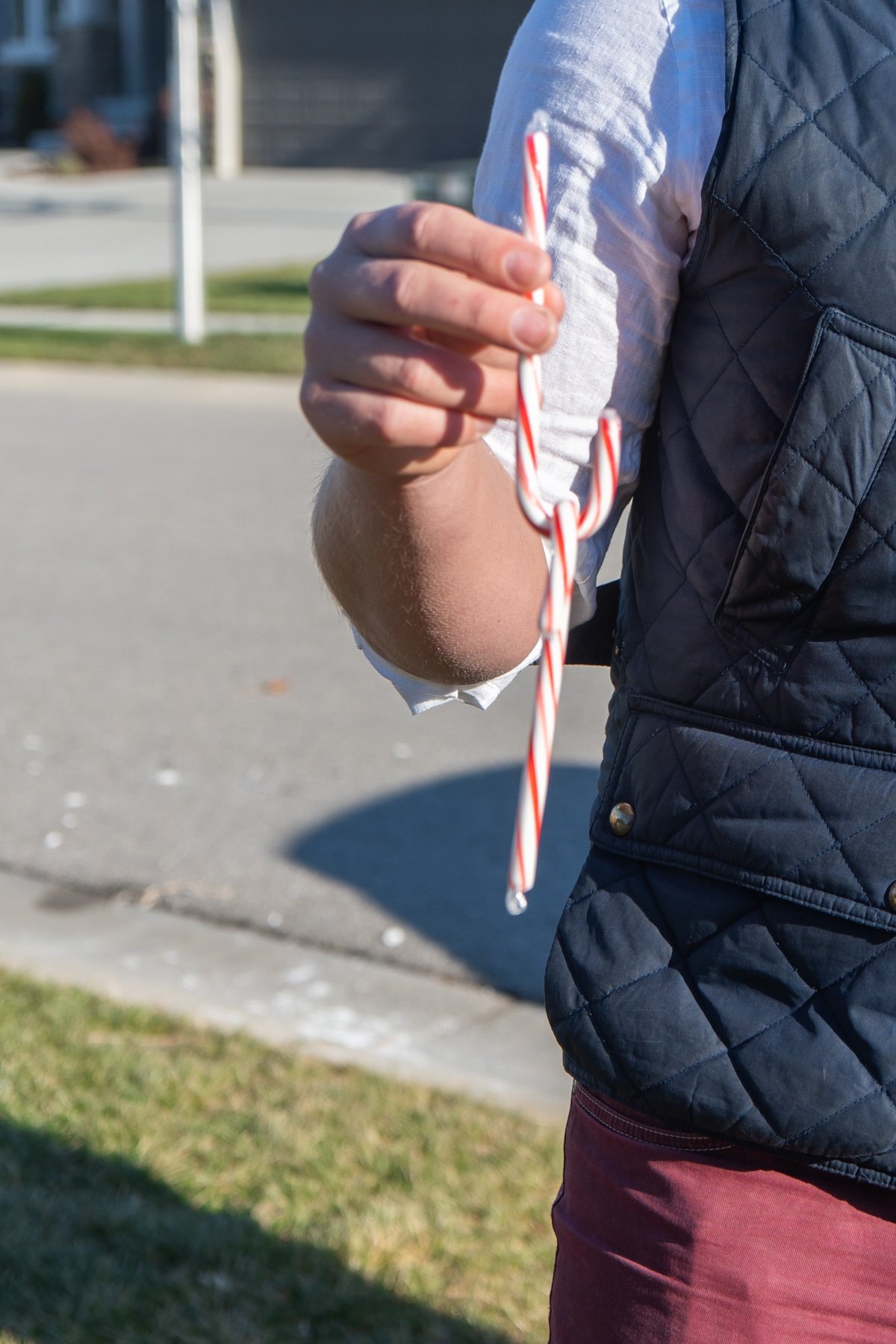 Man holding two candy canes hooked on to each other