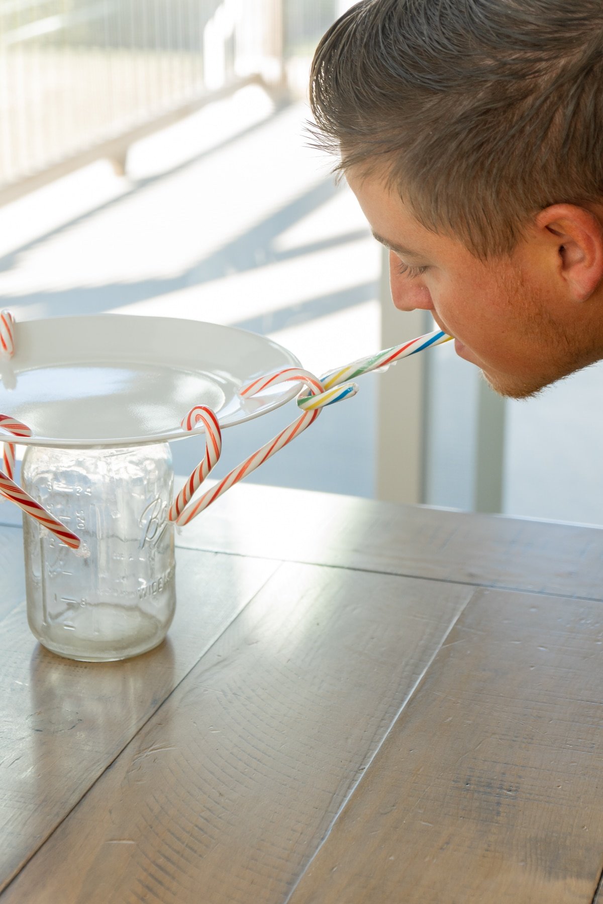 Candy canes on plates with a man 