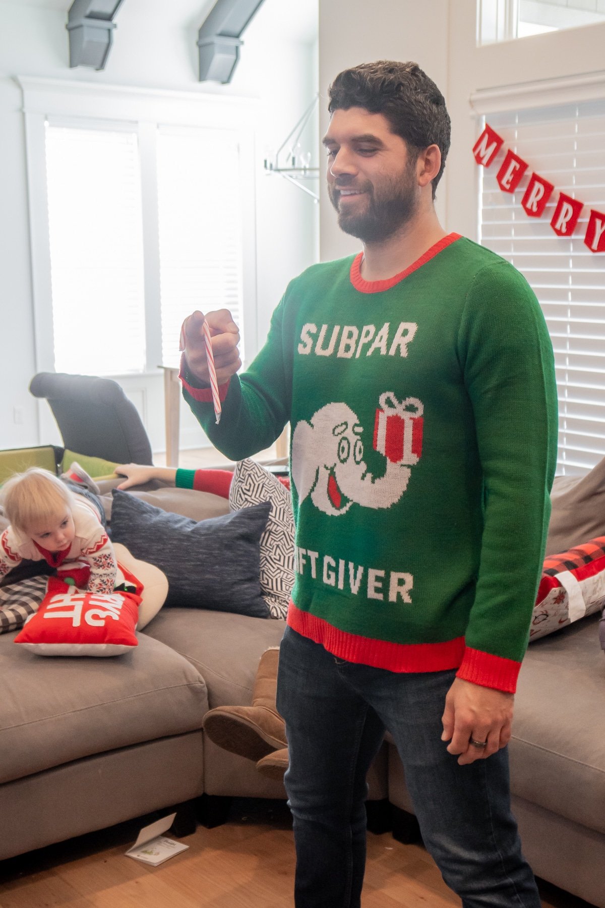 Man holding a candy cane on his hand