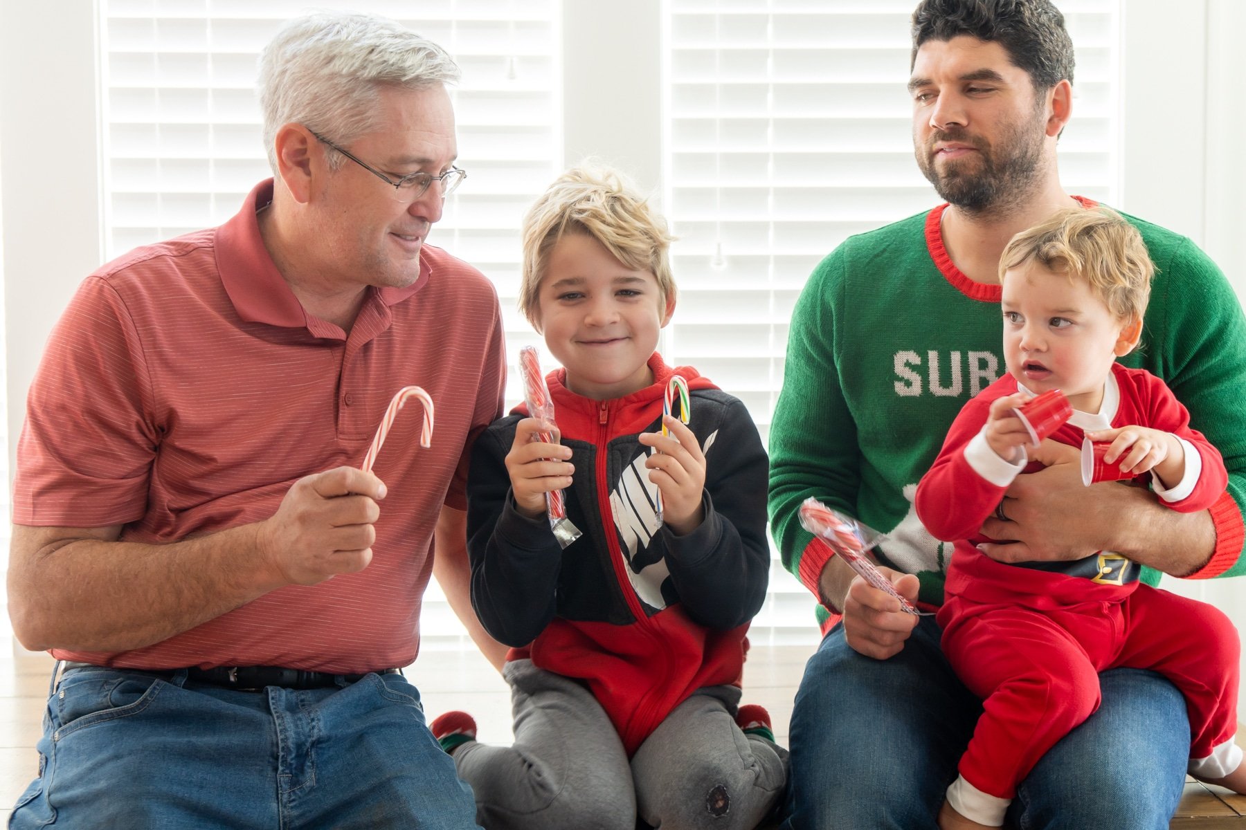 Family holding candy canes in their hand