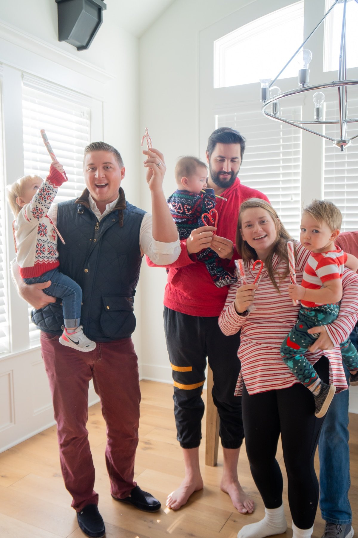 Family holding candy canes