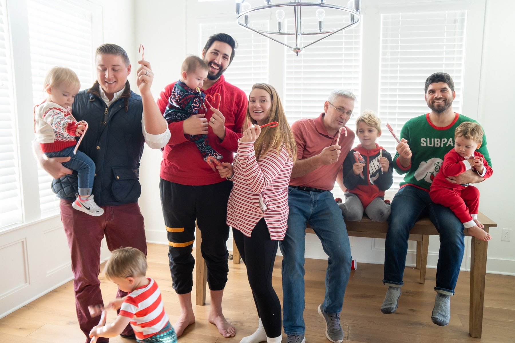 Happy people holding candy canes