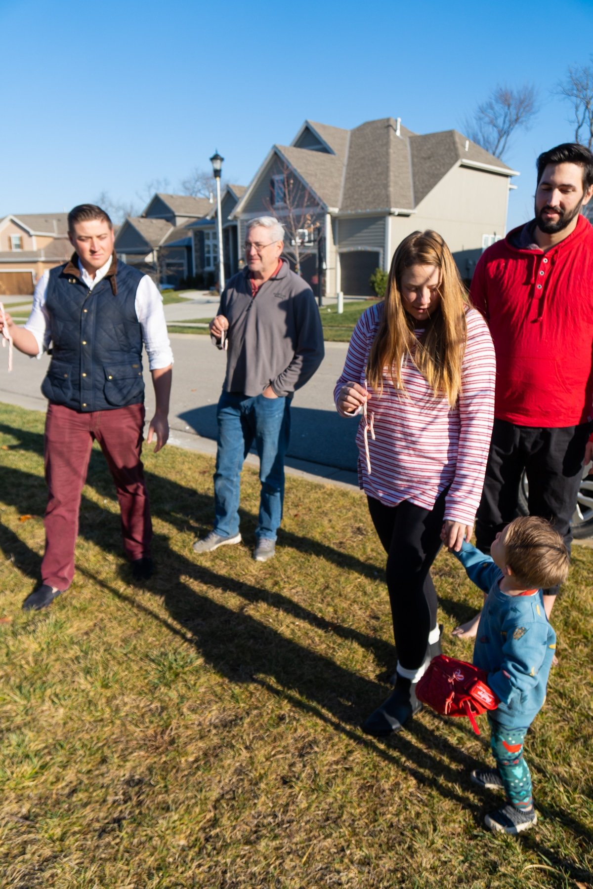 Group of people standing around holding candy canes