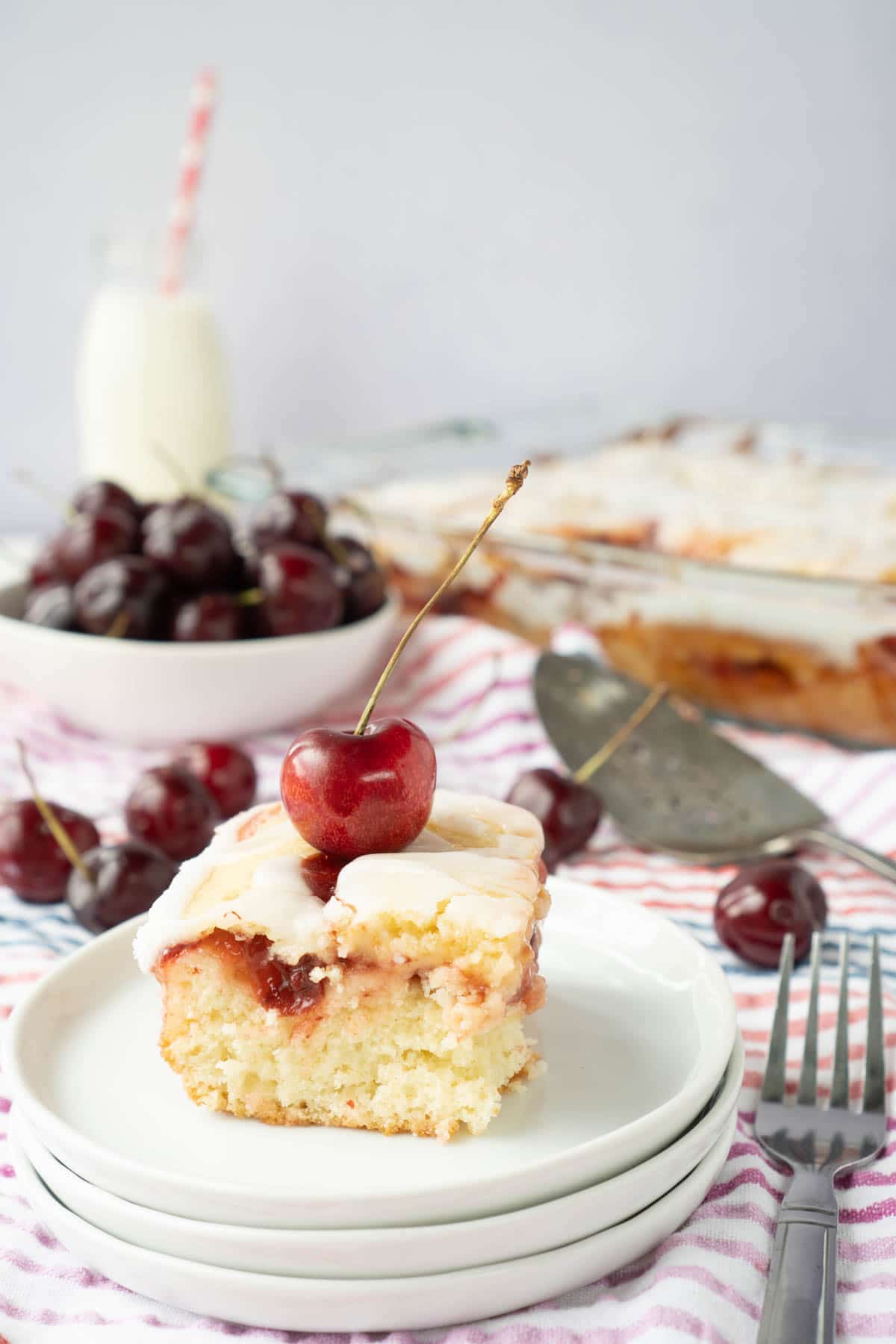 Piece of cherry cake on white plates