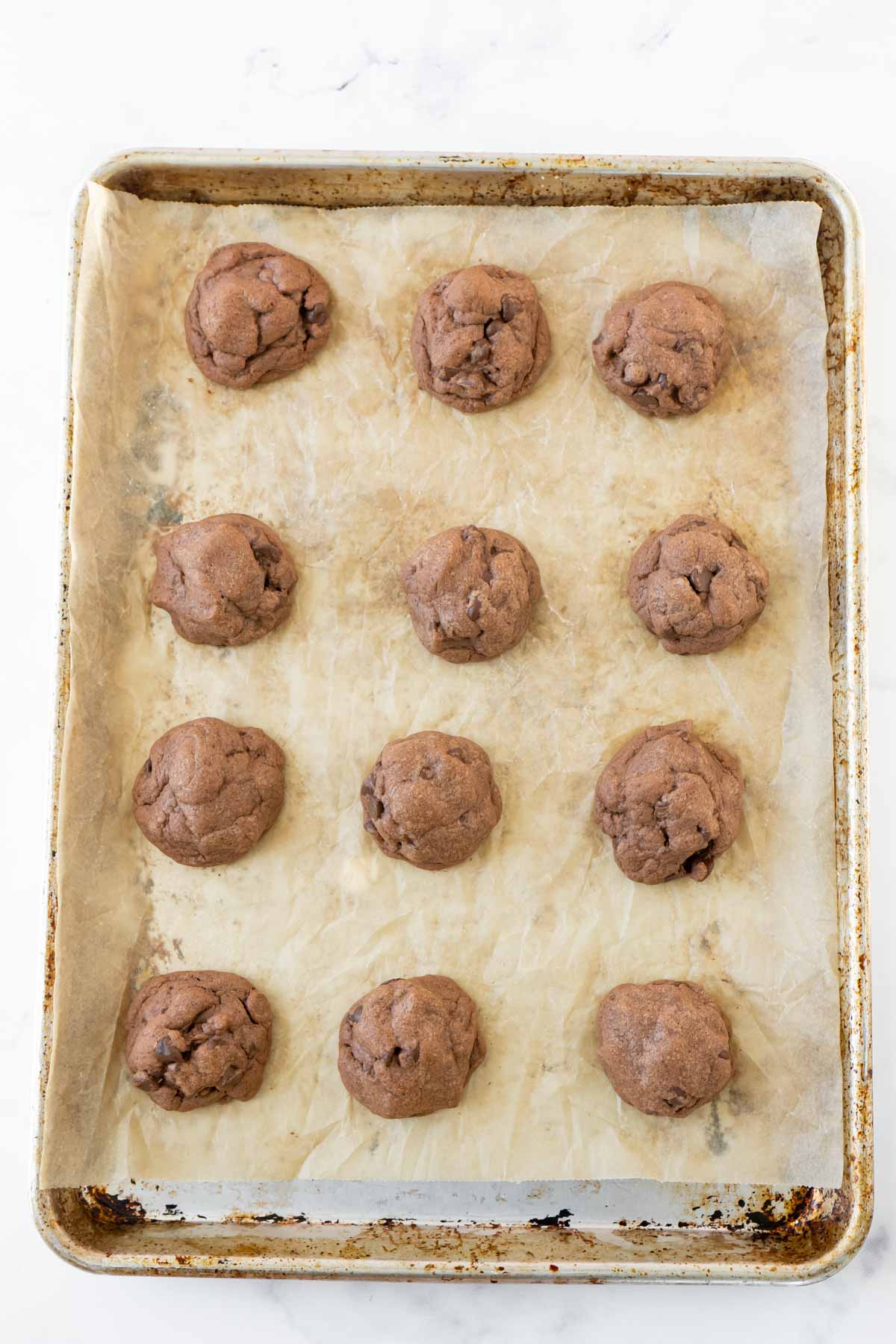 chocolate chip pudding cookies in rows on a baking sheet