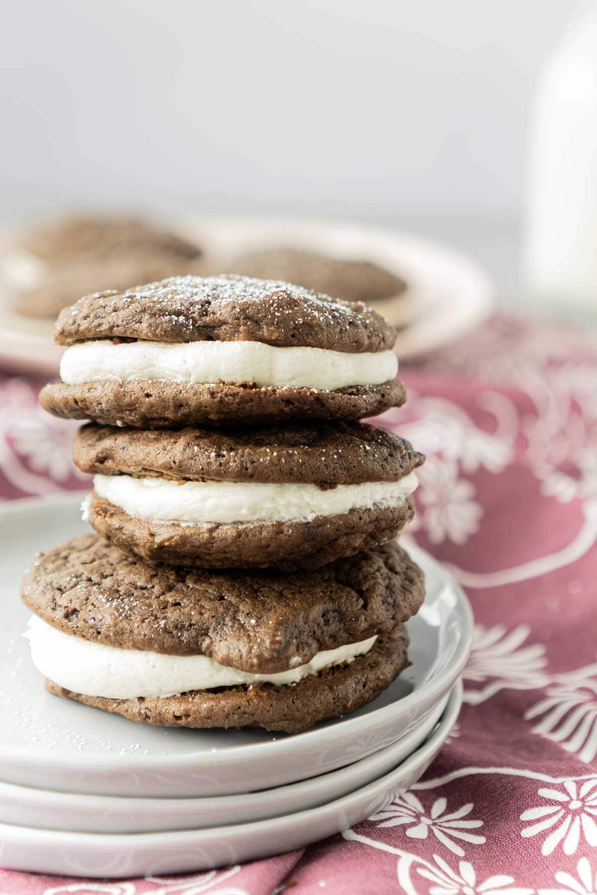 Three chocolate whoopie pies stacked on top of each other