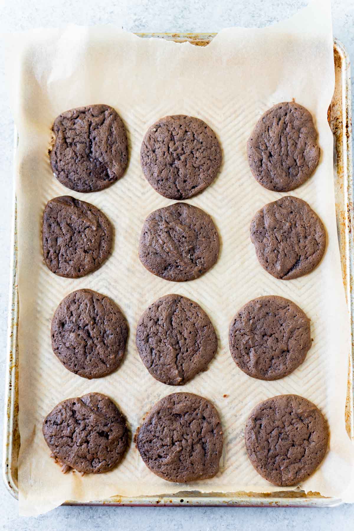 Chocolate whoopie pie cookies on a baking sheet cooling