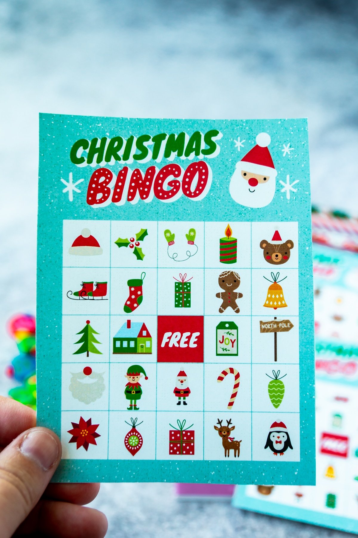 Woman's hand holding a Christmas bingo card