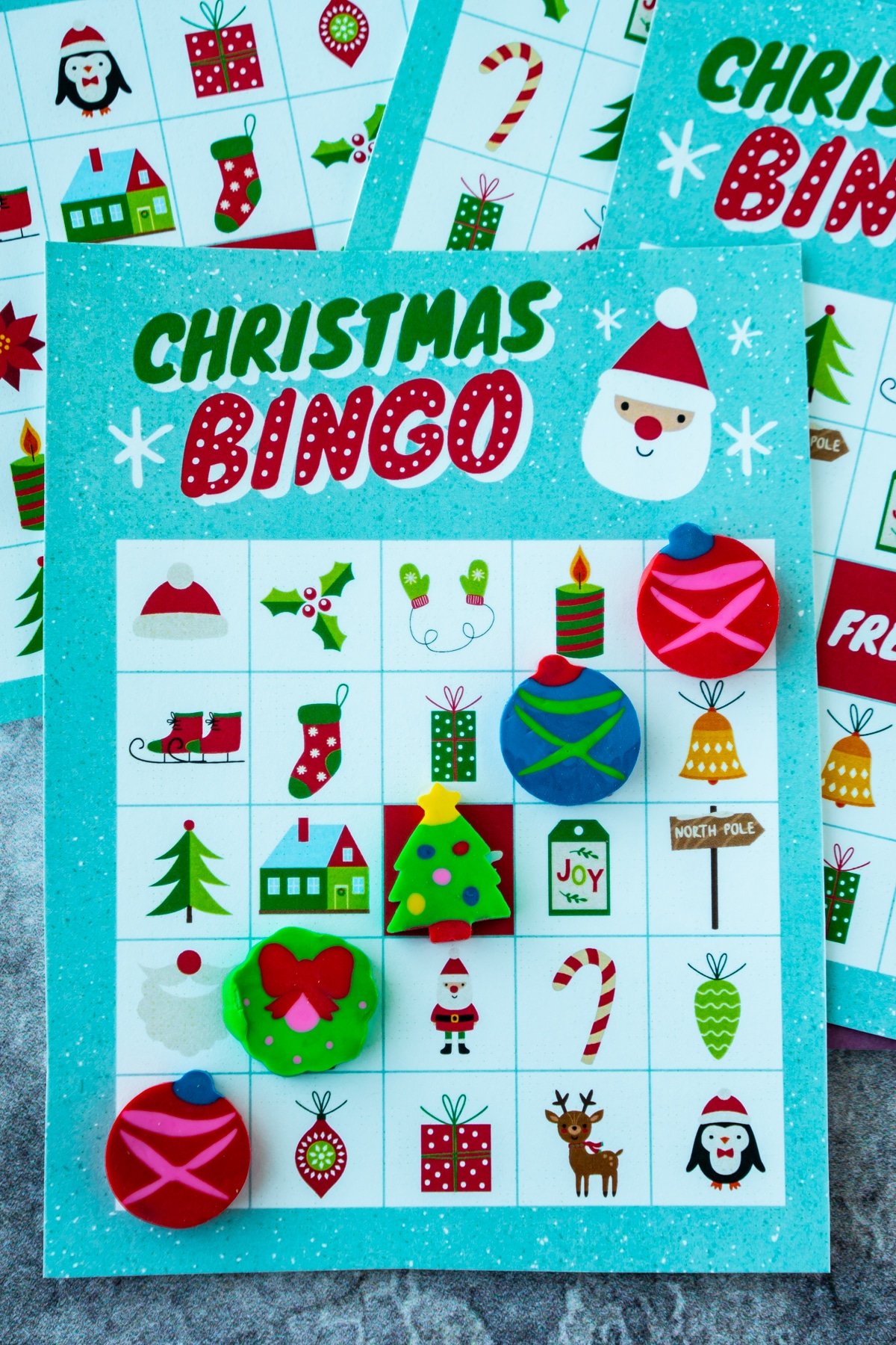 Christmas bingo card with Christmas erasers in a line