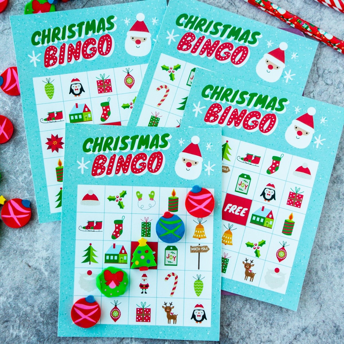 Four Christmas bingo cards stacked on top of each other