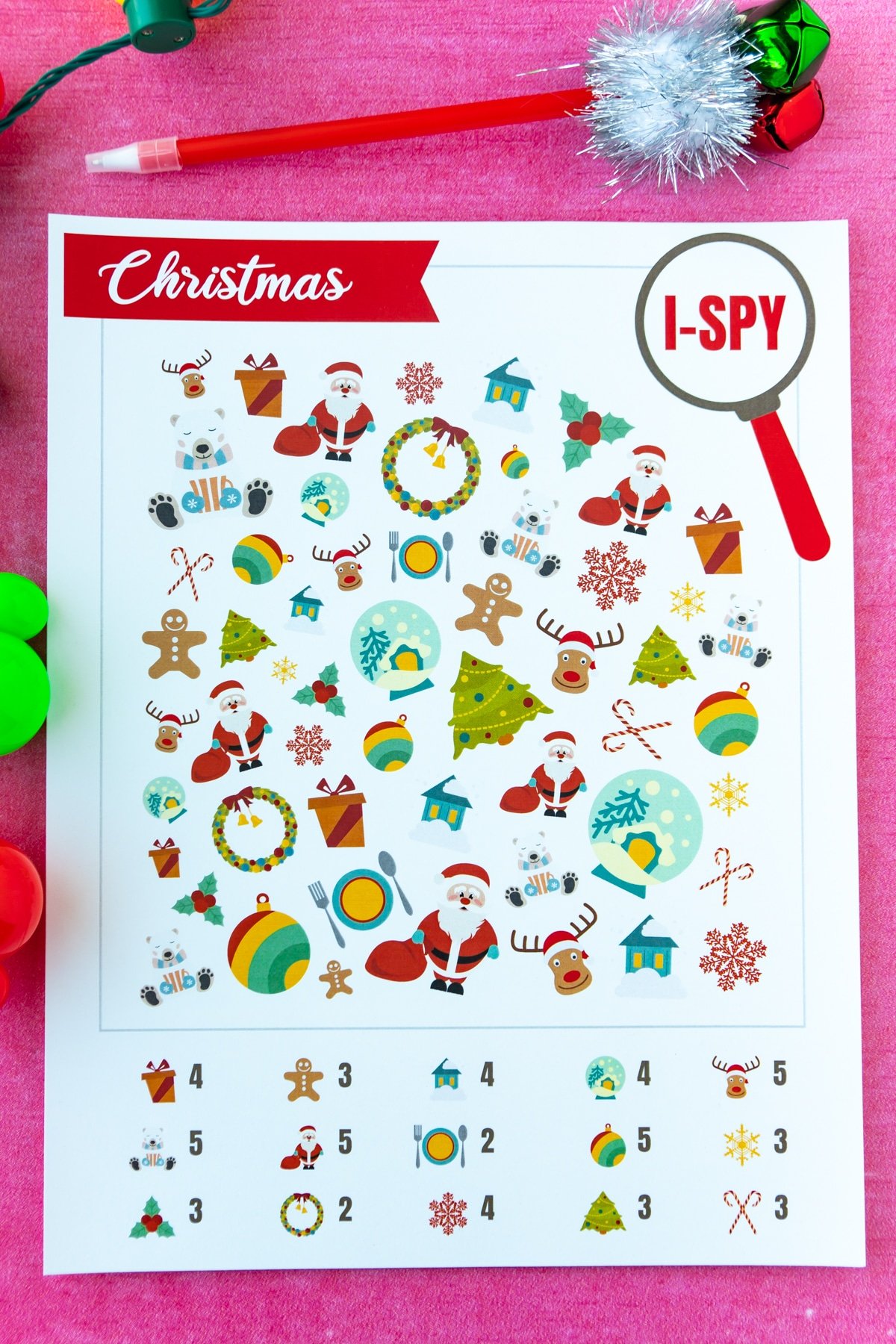 Printed out Christmas i-spy game on a pink background