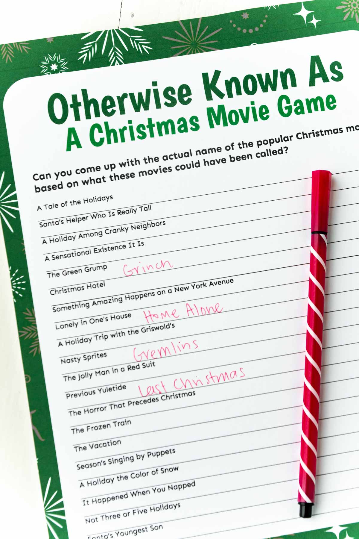 Christmas movie trivia game with a red pen on top