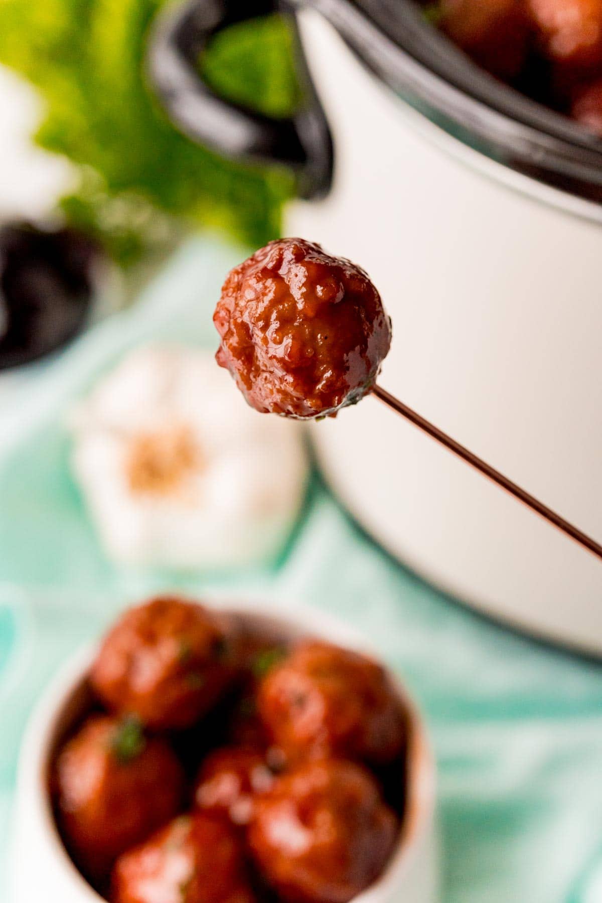 Toothpick with a crockpot grape jelly meatball