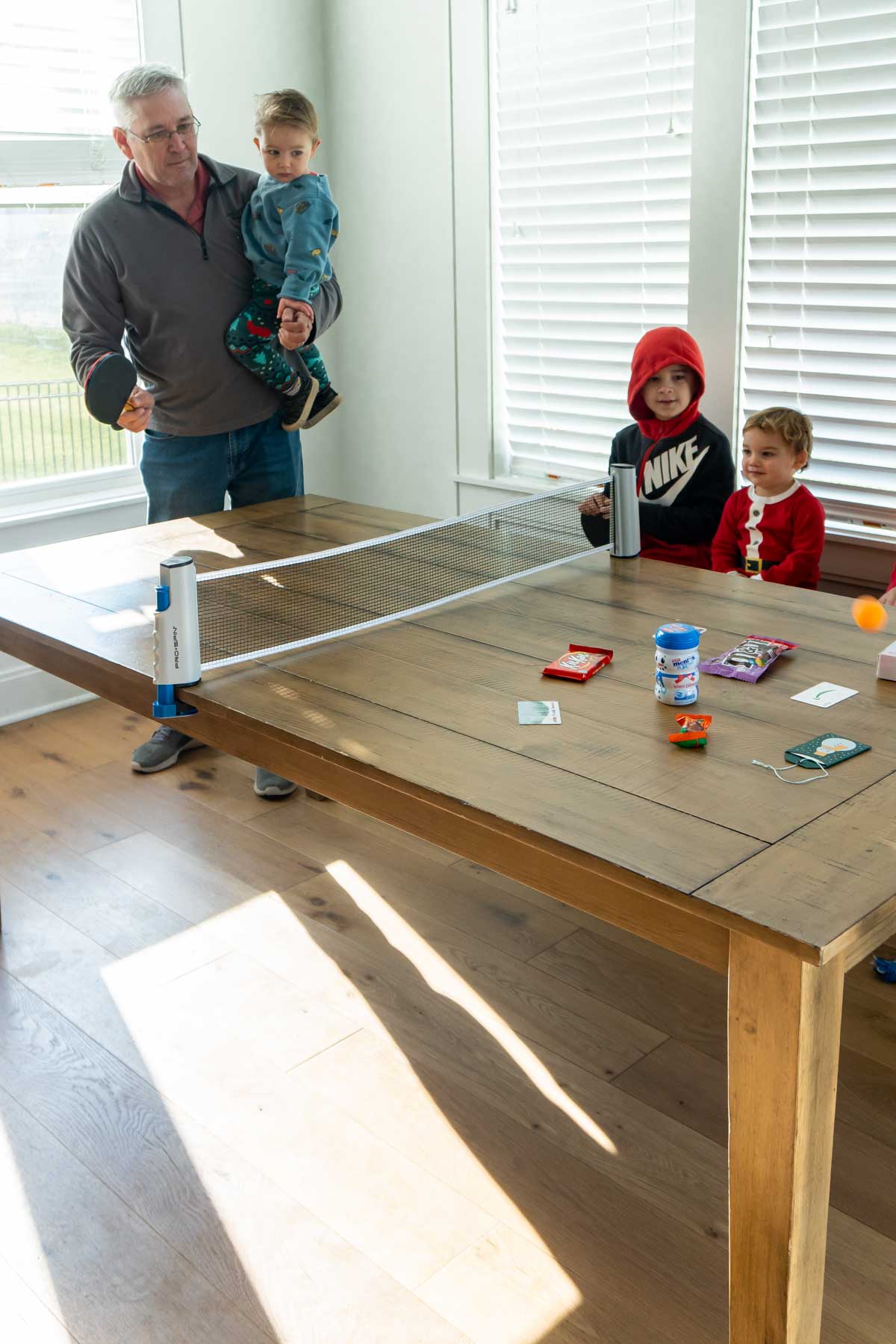 Grandpa hitting a ping pong ball