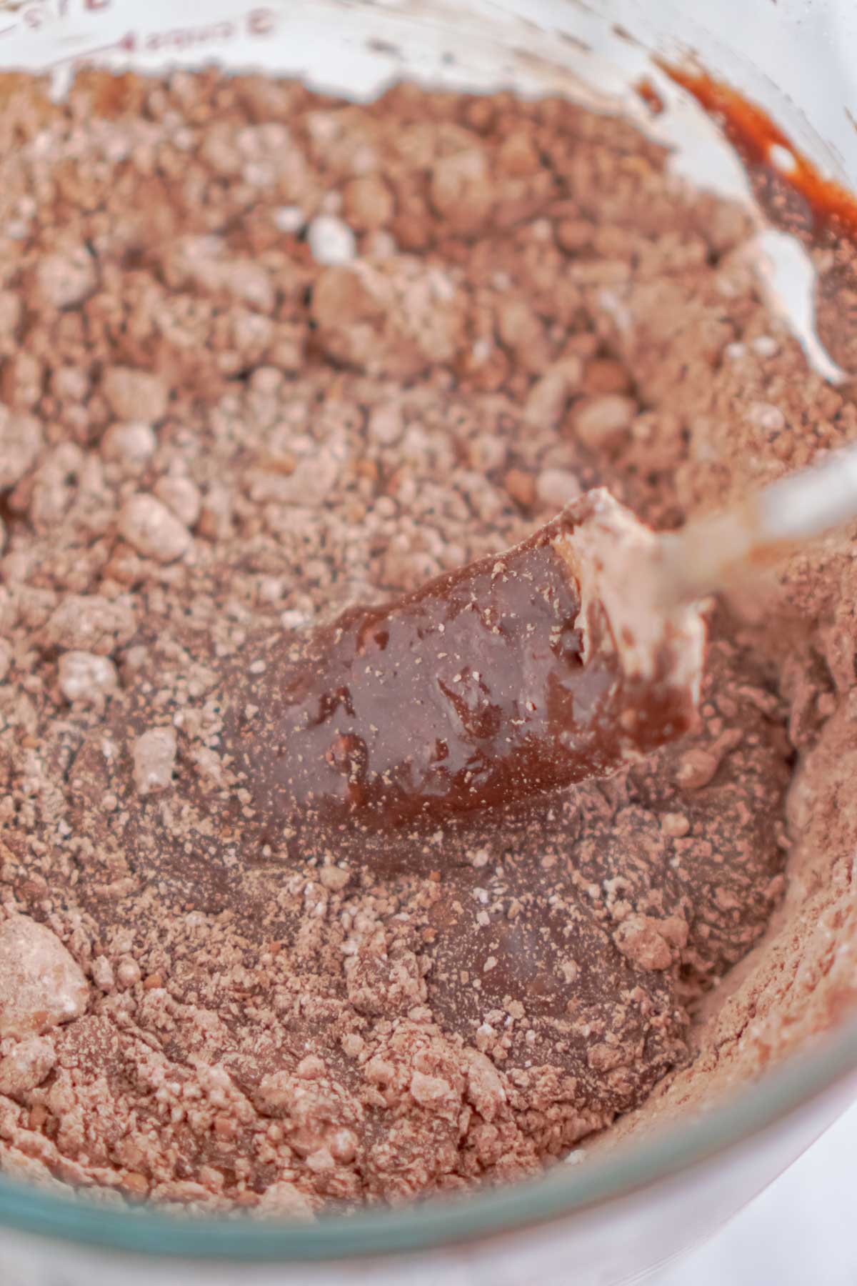 Spatula in a bowl of chocolate frosting