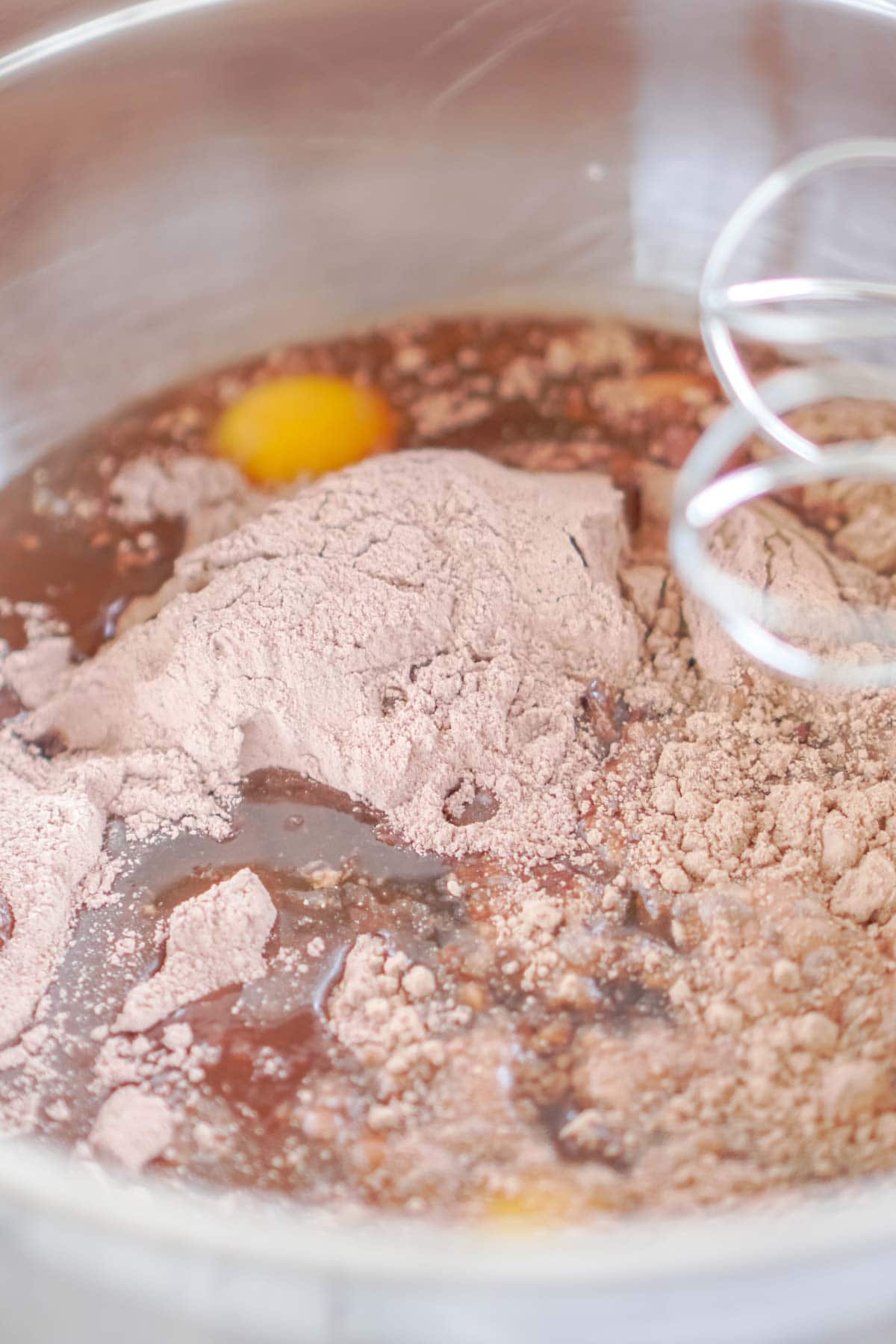 Metal bowl with cake mix oil and eggs