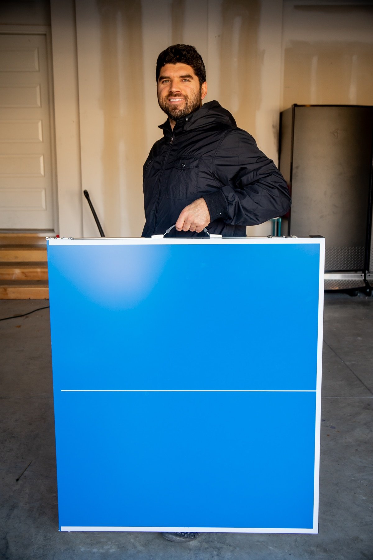 Man holding a foldable ping pong table