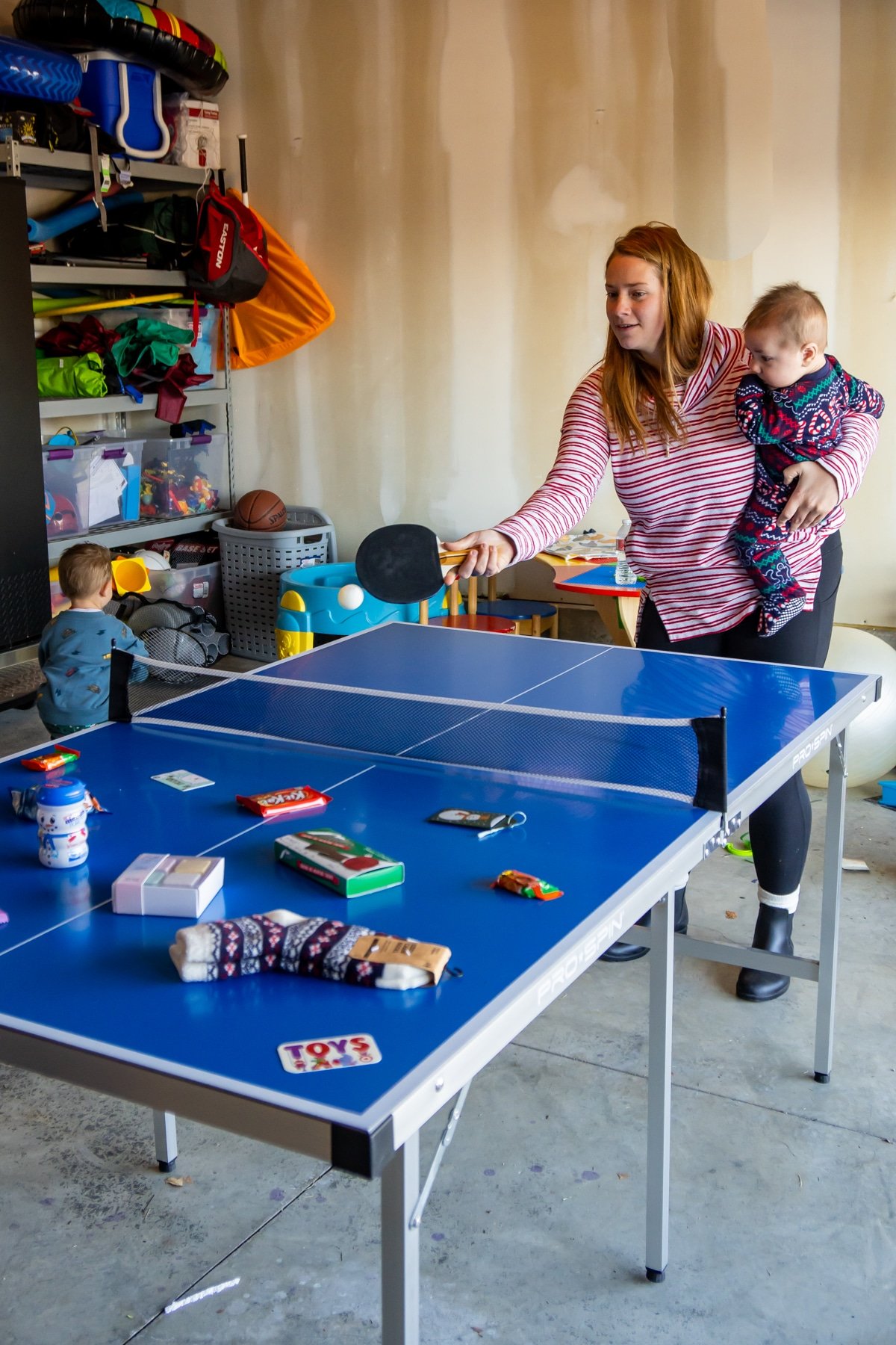 Woman hitting a ping pong on a table with prizes