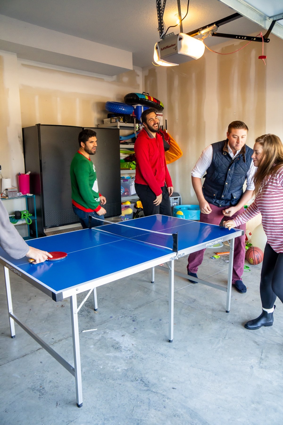 Family playing ping pong games around a ping pong table