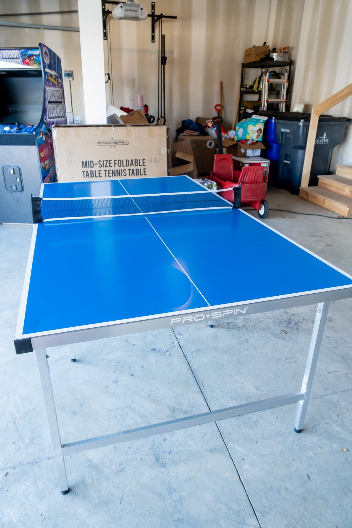 Pro-spin foldable ping pong table in a garage