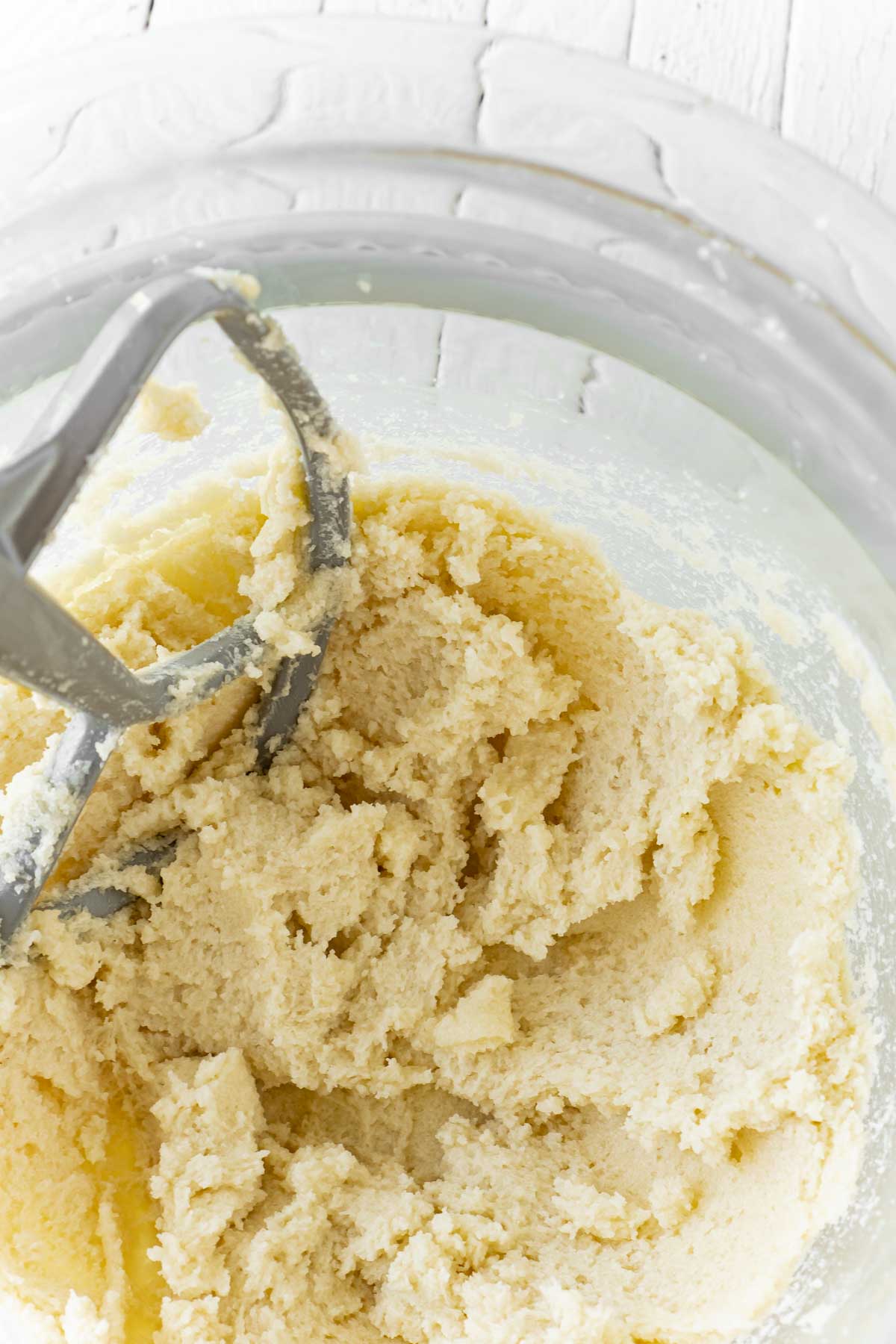 Glass mixing bowl with butter and sugars creamed together