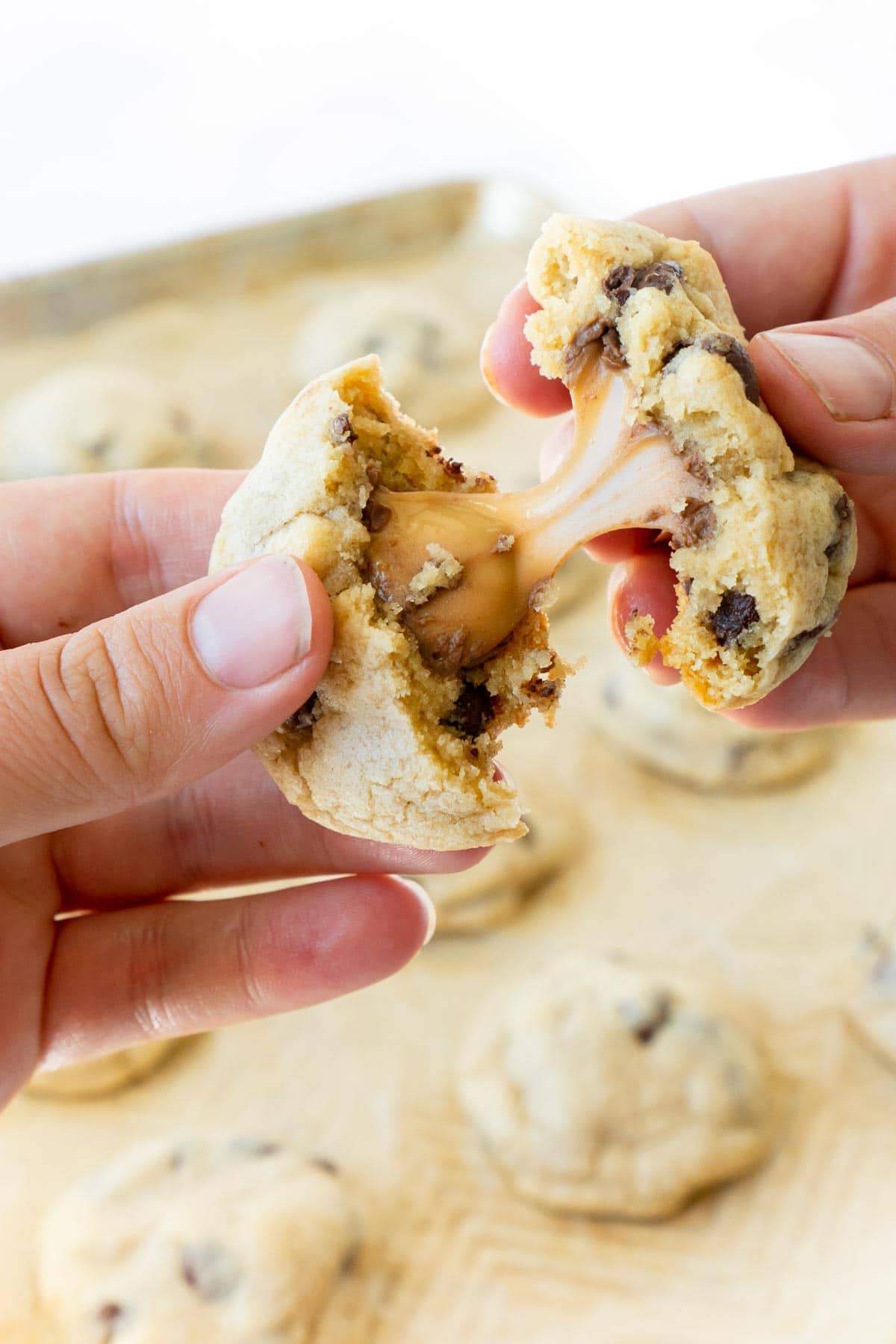 women pulling a rolo cookie apart 