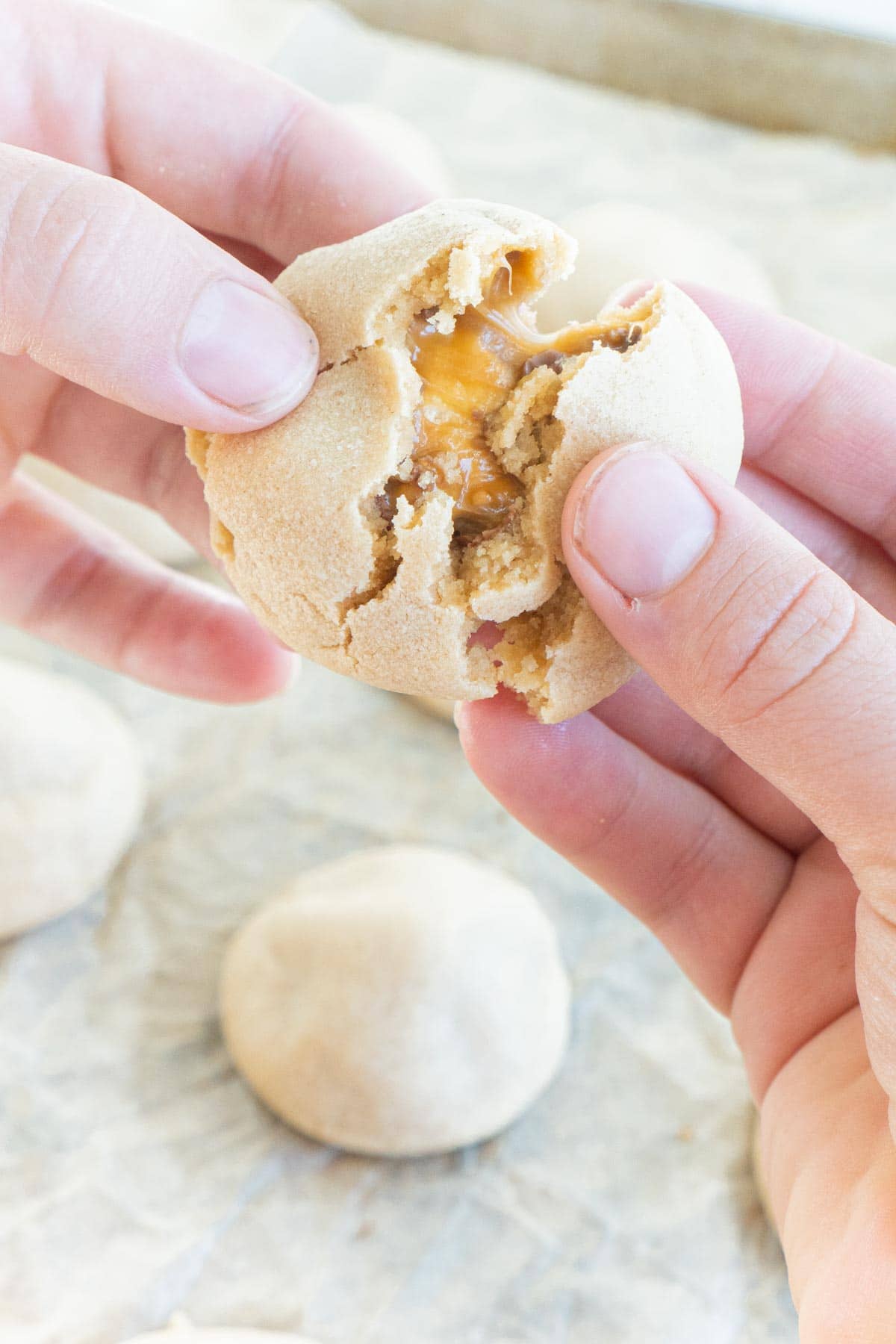 Woman's hand pulling a snickers cookie apart