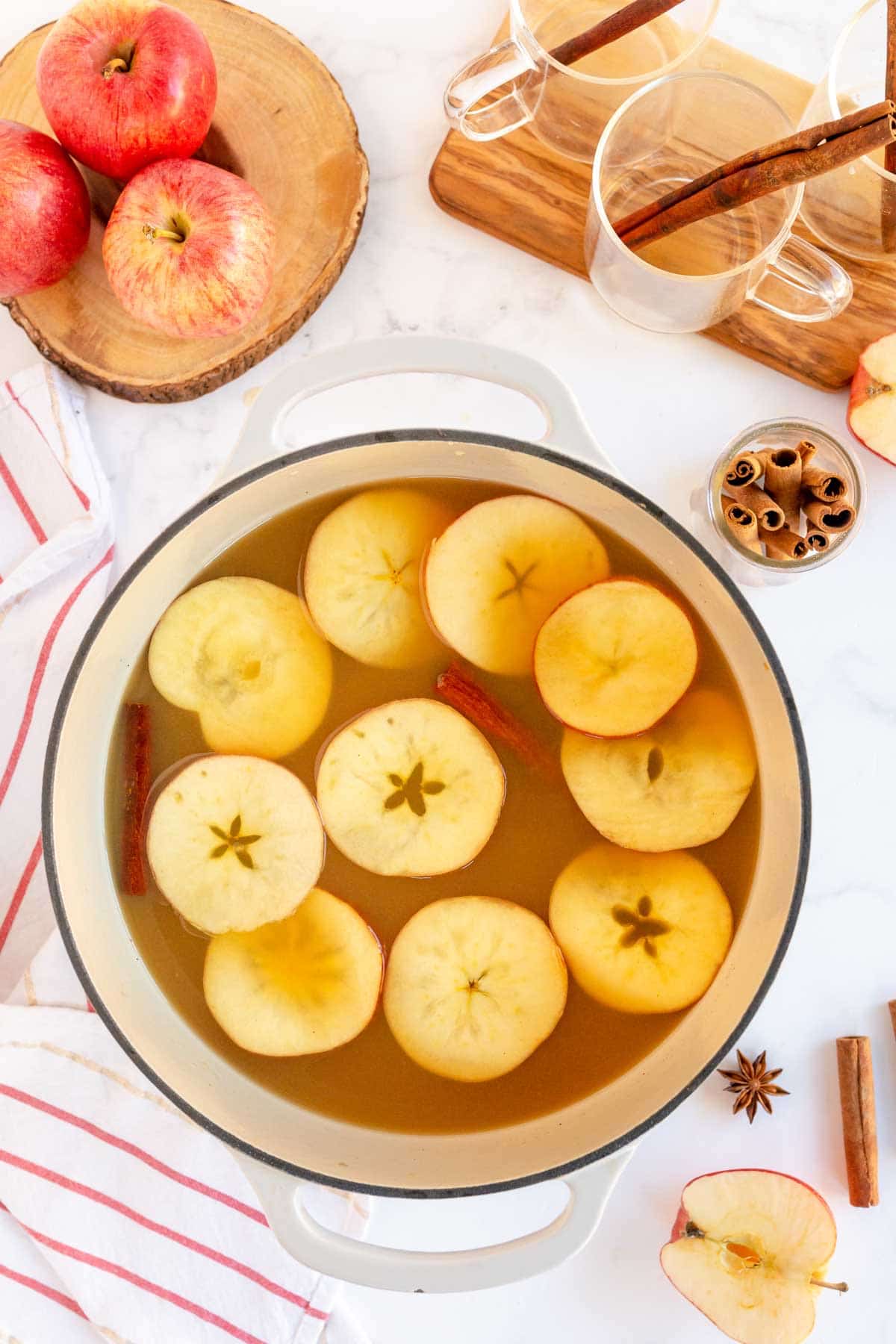 Pot with spiced apple cider and floating apples