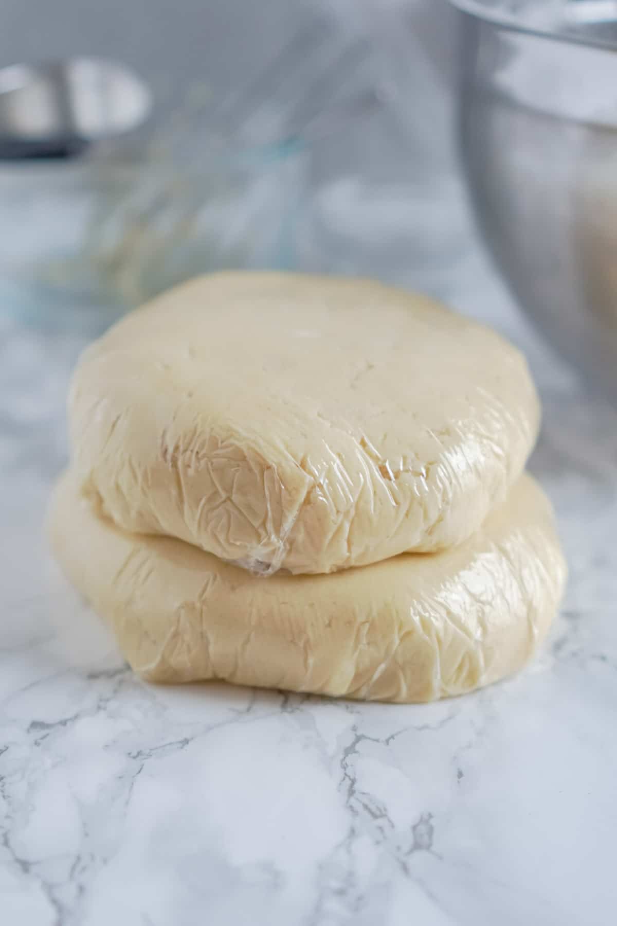 dough for sugar cookie bites wrapped in plastic wrap