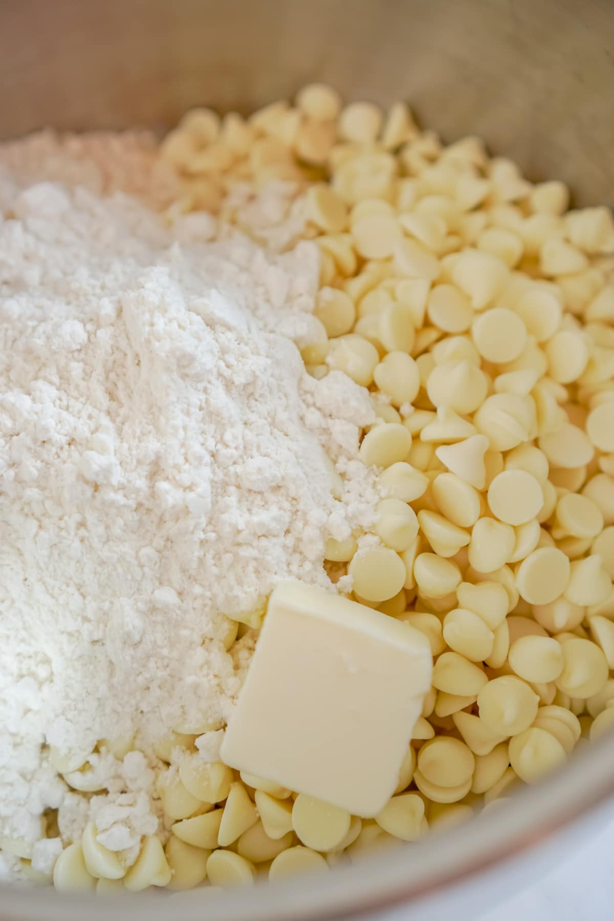 White chocolate chips and butter in a bowl