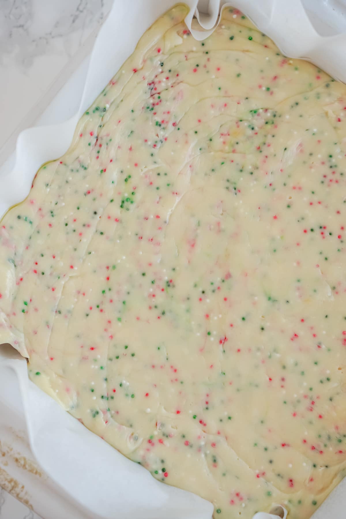 White chocolate fudge with sprinkles in a pan