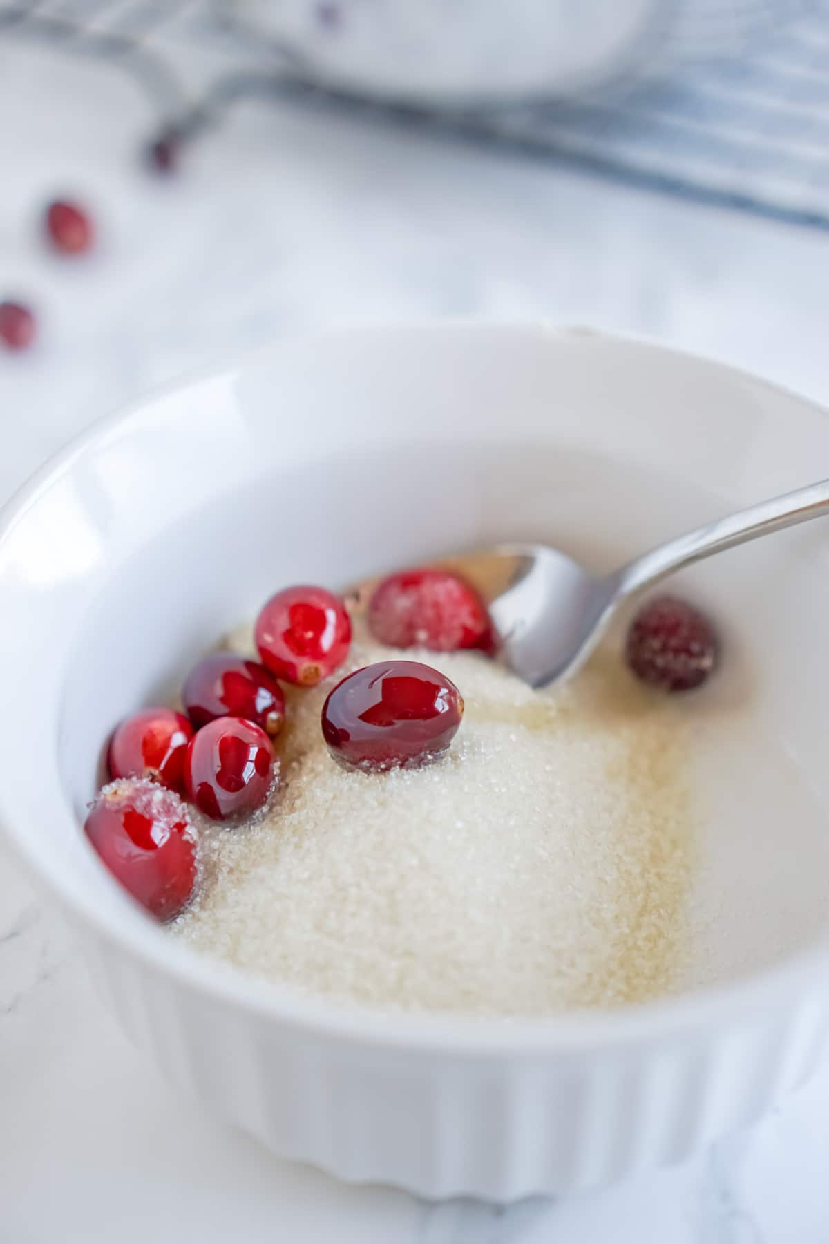 bowl of sugar with cranberries in them