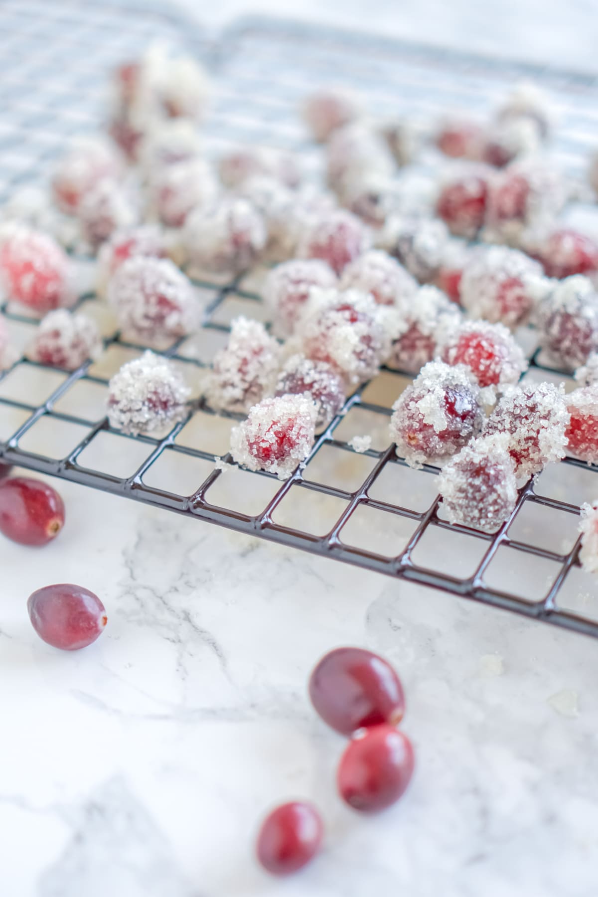 sugared cranberries on a cooling rack