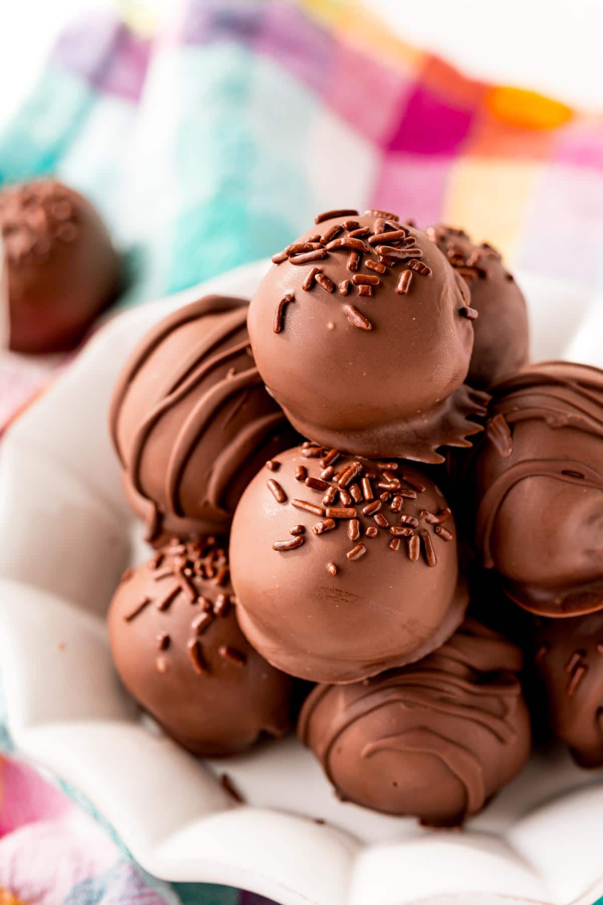 A pile of brownie balls on a white plate