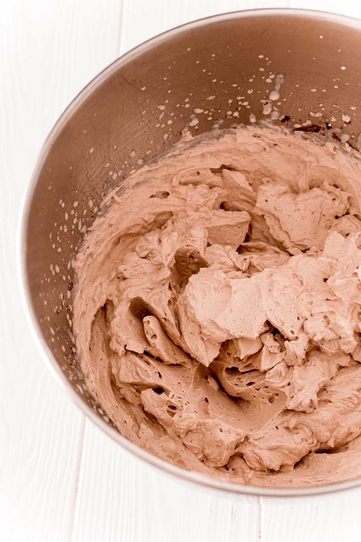 Chocolate whipped cream in a metal mixing bowl