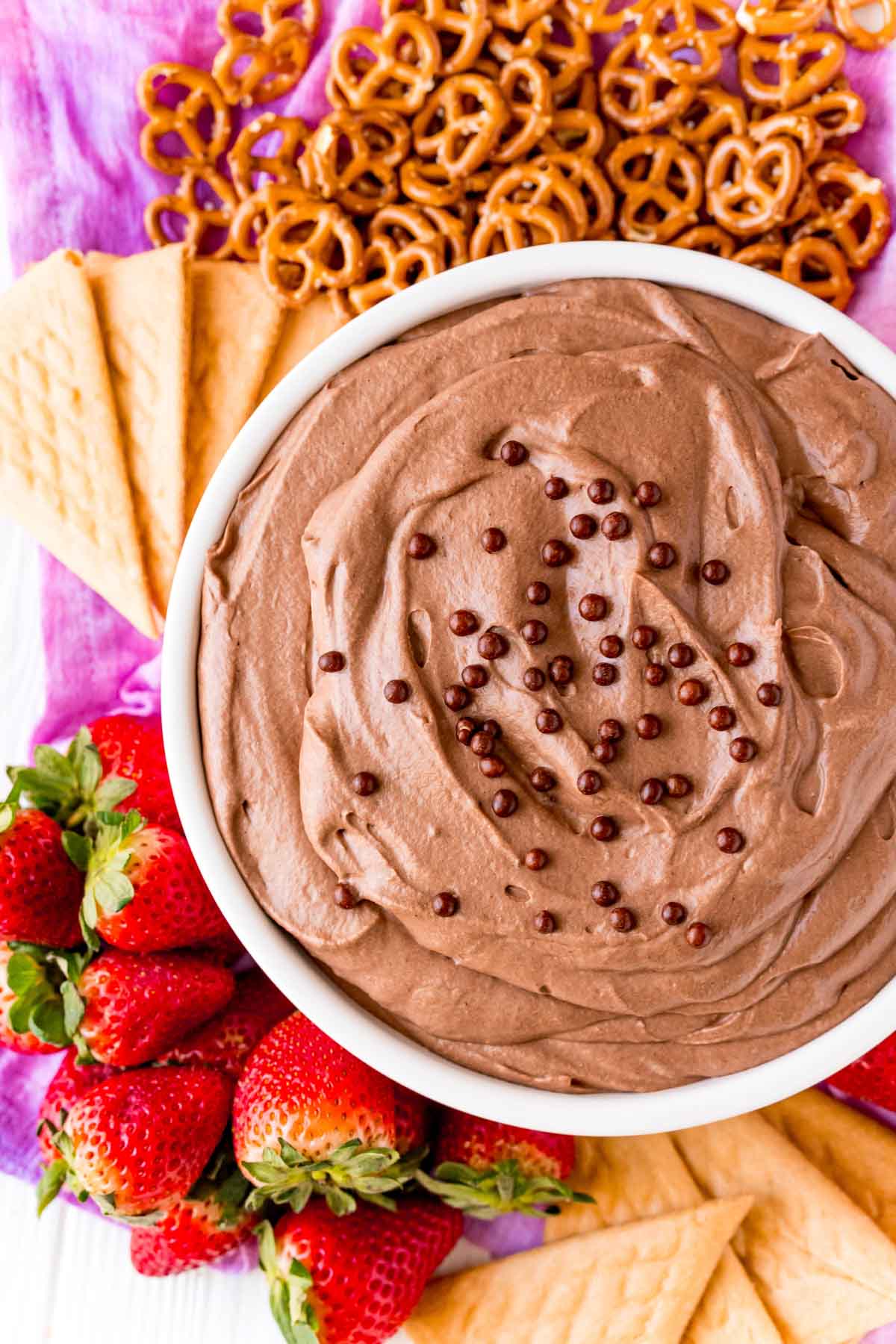 White bowl with brownie batter dip and dippers around it