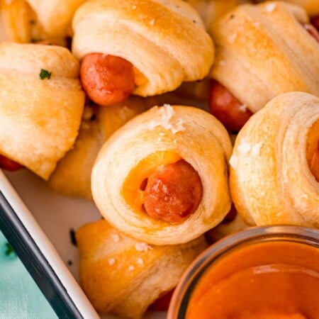 Tray full of cheddar pigs in a blanket