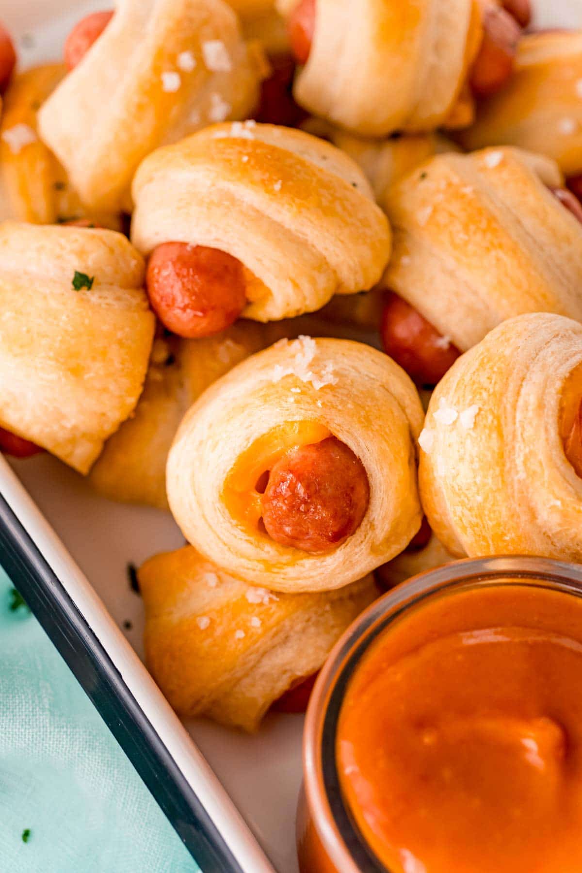 Tray full of cheddar pigs in a blanket