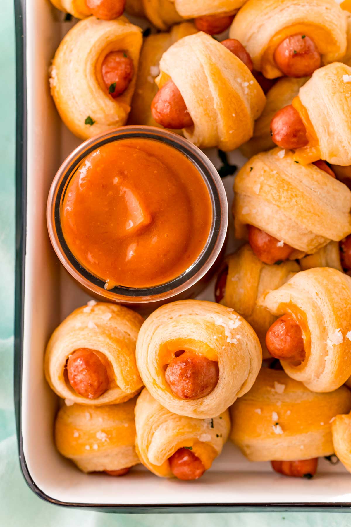A metal tray of cheddar pigs in a blanket
